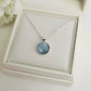 Necklace with a round ashes keepsake pendant on a white memory within jewelry box