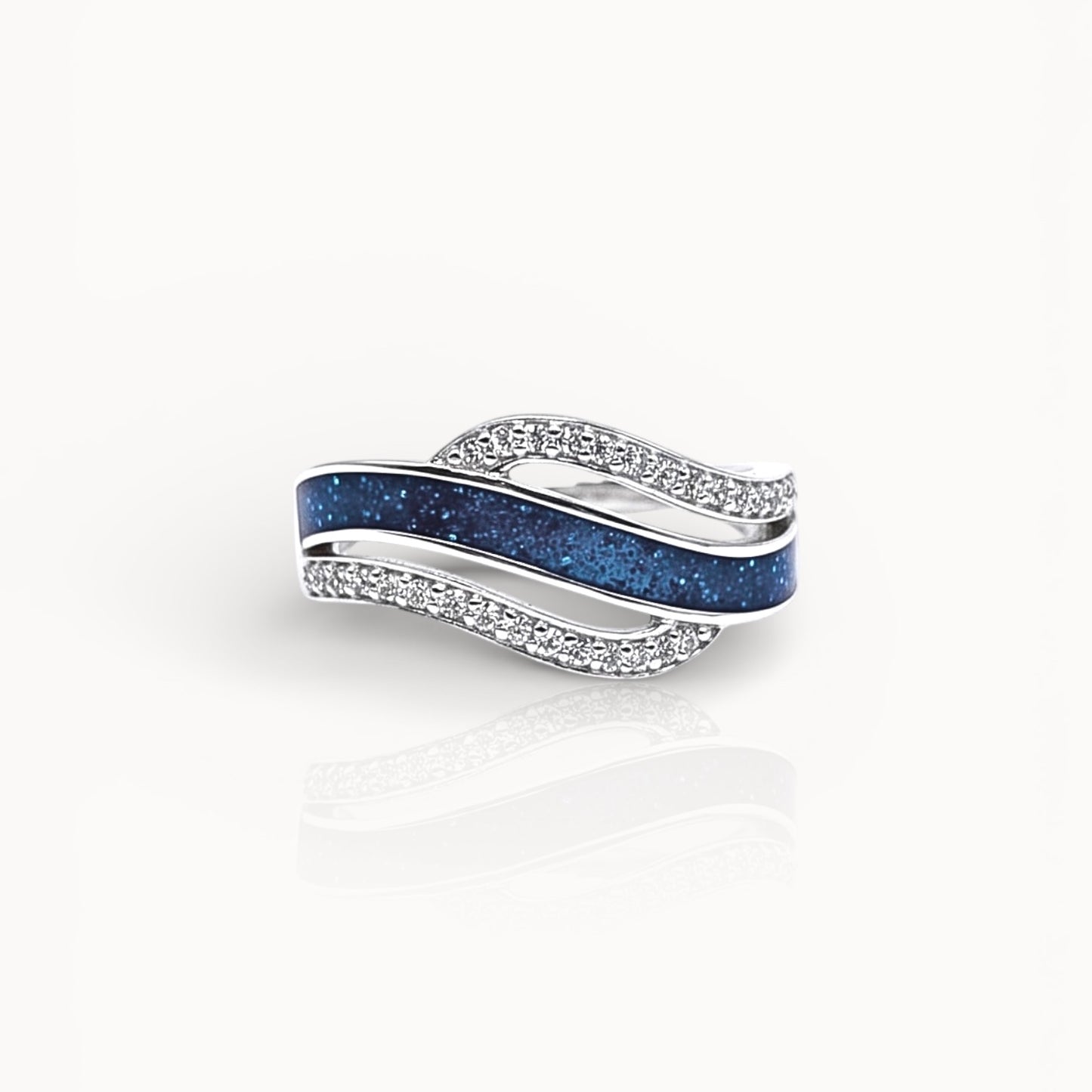 Silver ring with blue ashes channel on a white background