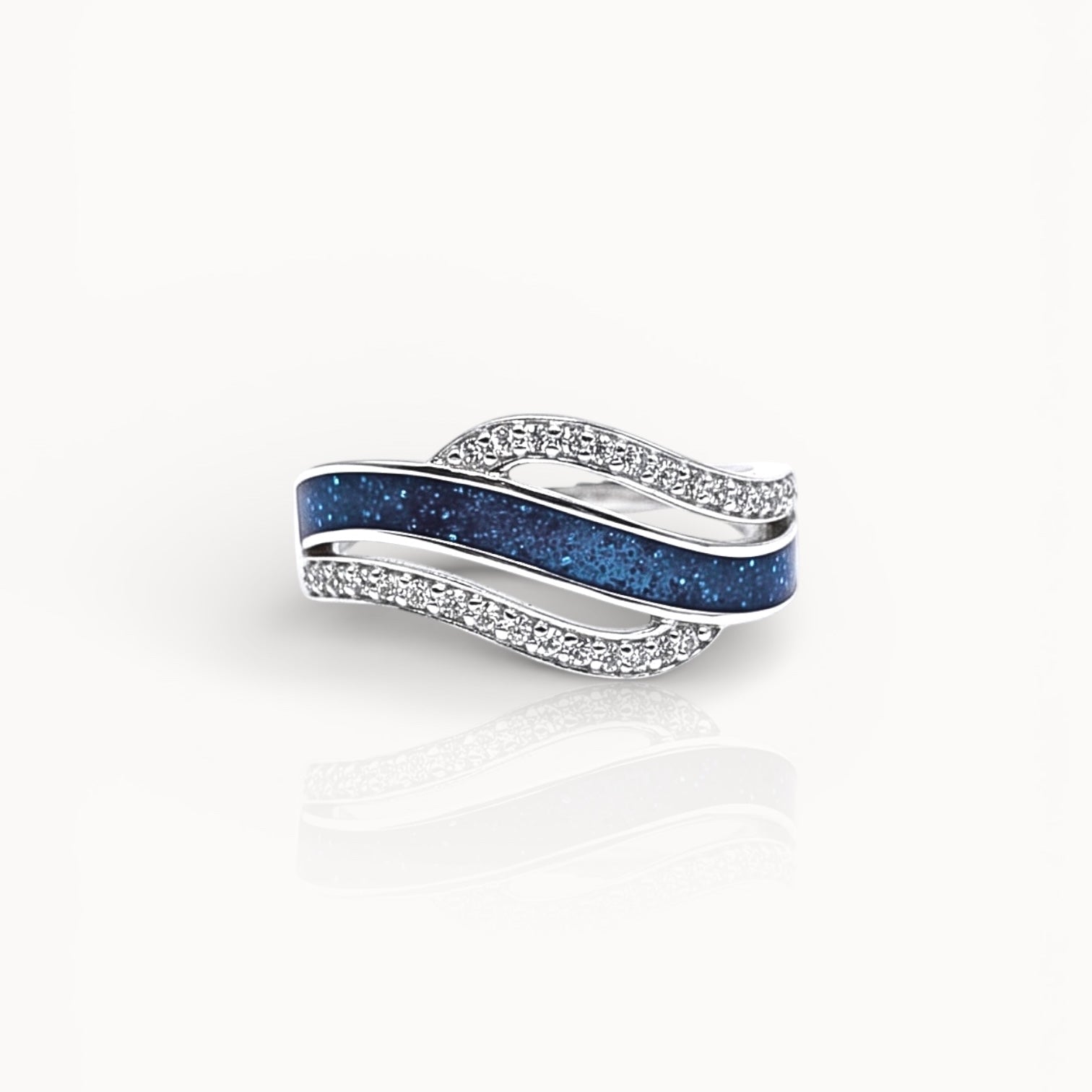 Silver ring with blue ashes channel on a white background