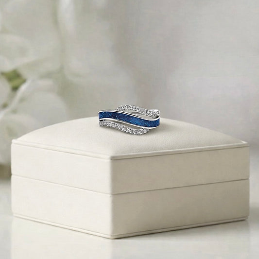 Silver ring with blue ashes keepsake channel on a white memory within jewelry box