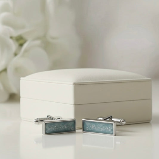 Rectangular Eros ashes cufflinks with a textured design on a white surface next to a Memory Within jewelry box.