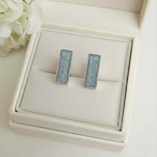 Silver rectangular Cufflinks in a white Memory Within jewellery box with flowers in the background