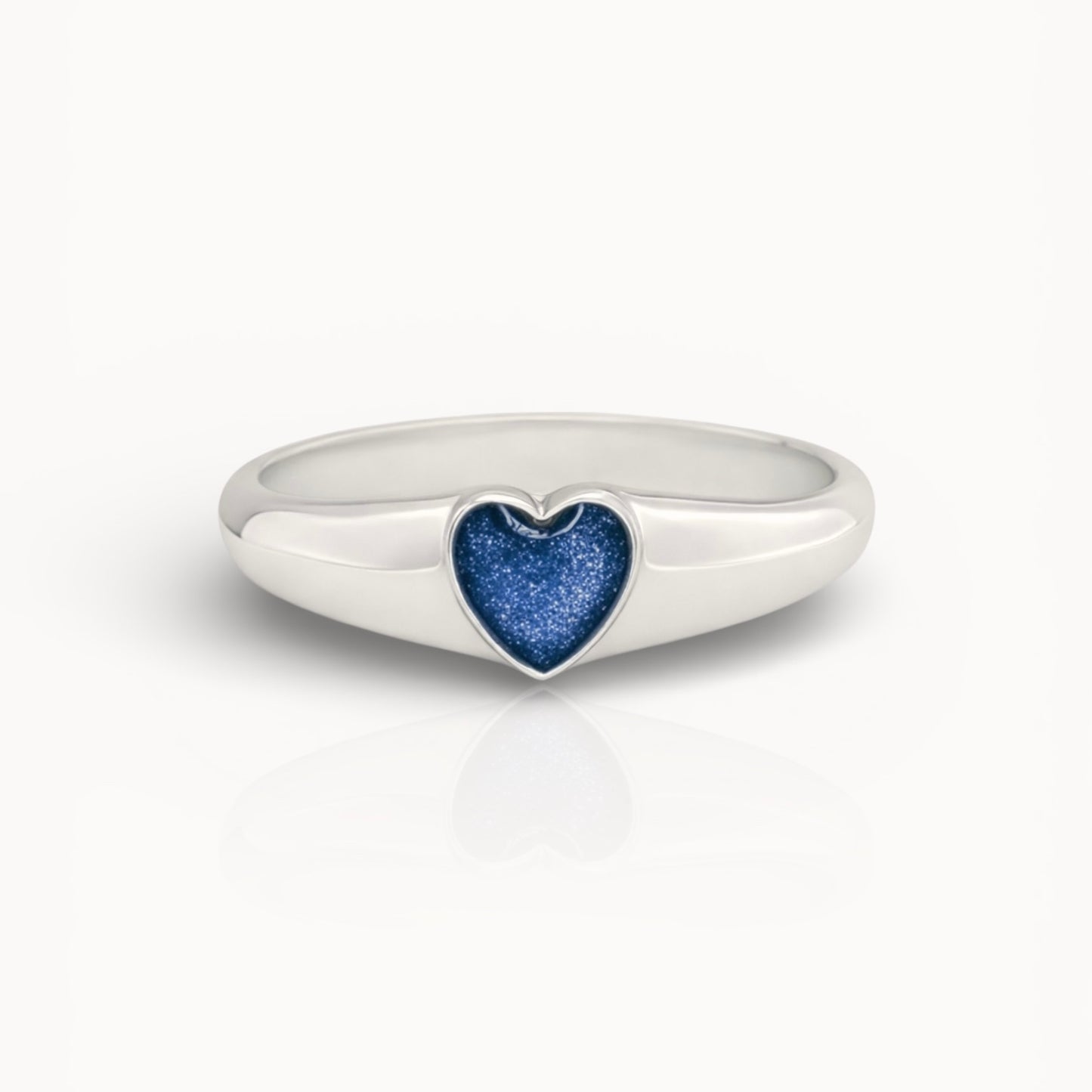 Silver ring with a blue heart ashes keepsake stone on a white background