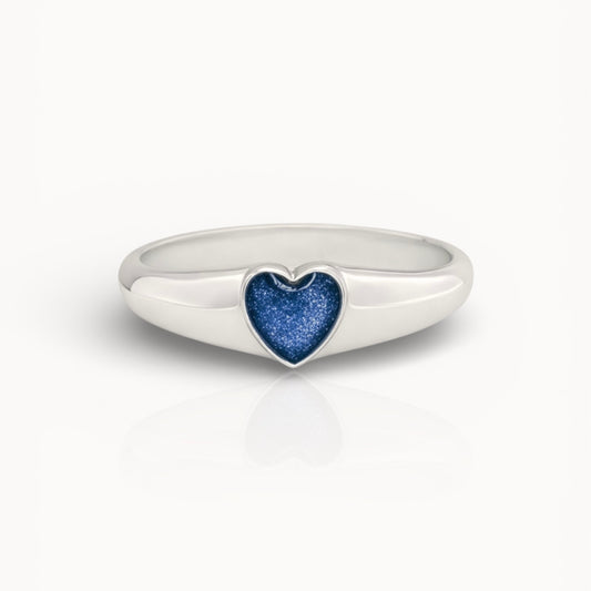 Silver ring with a blue heart ashes keepsake stone on a white background