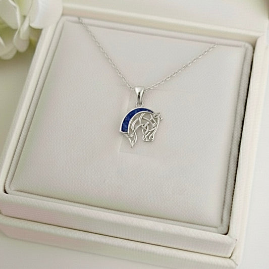 Silver horse head ashes memorial keepsake pendant with blue stone on a necklace, displayed in a white memory within jewelry box.