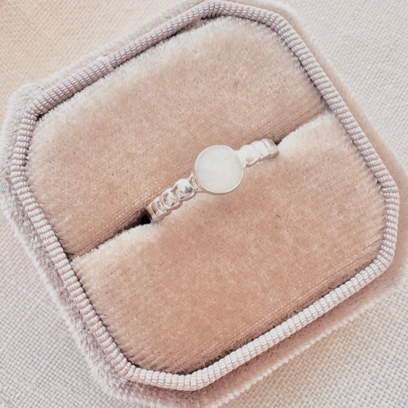 Luna Bobble Band sterling silver breastmilk ring with round handmade breastmilk stone and delicate beaded band.