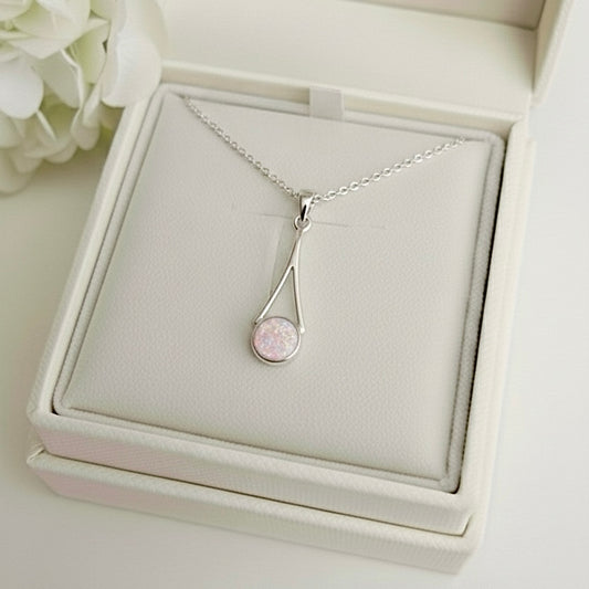Silver necklace with a pink opal ashes keepsake pendant in a memory within jewelry box