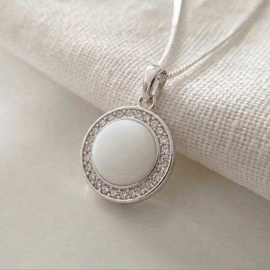 Luna Halo breastmilk pendant in sterling silver with round breastmilk centre and cubic zirconia halo.