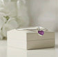 Silver bangle with a purple heart-shaped ashes keepsake charm on a white Memory Within jewelry box.