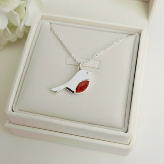 Silver necklace with a Robin ashes keepsake pendant on a white memory within jewelry box