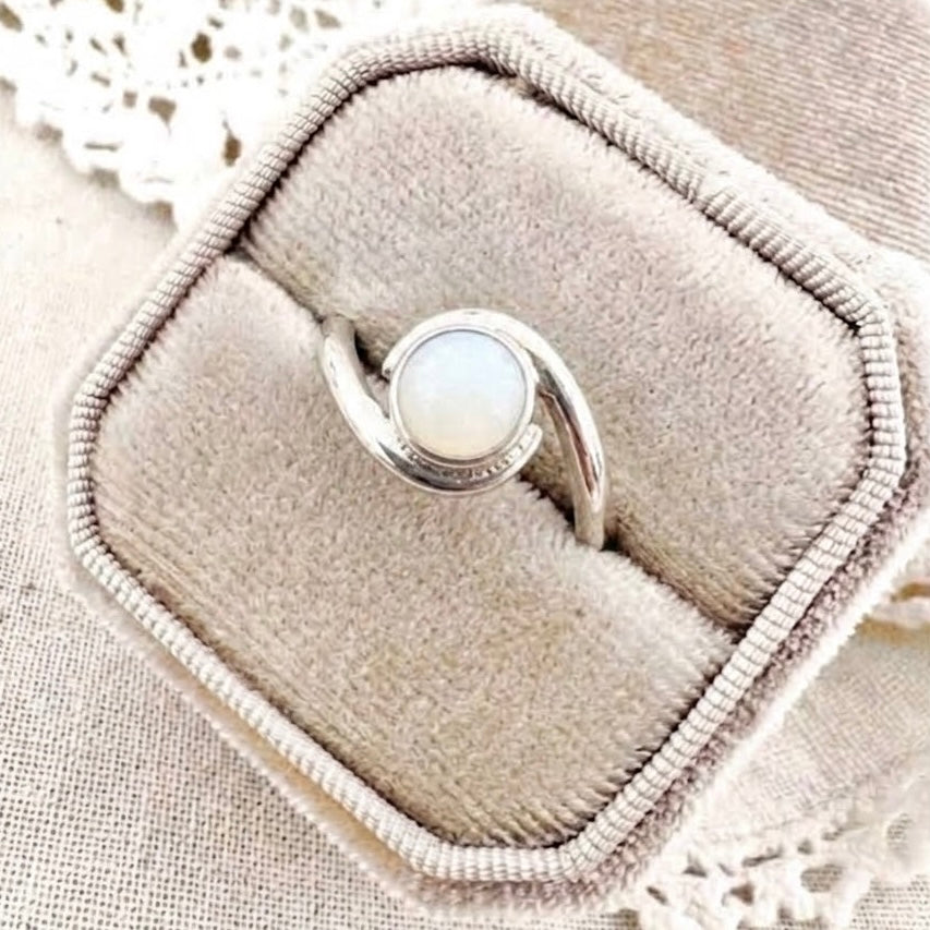 Twist Breastmilk Ring with round breastmilk stone and flowing twist design, available in sterling silver or 9ct gold.