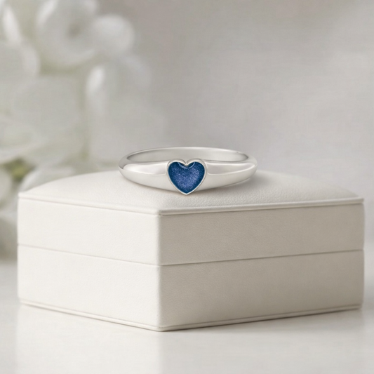 Silver ring with a blue heart ashes keepsake stone on a white memory within box